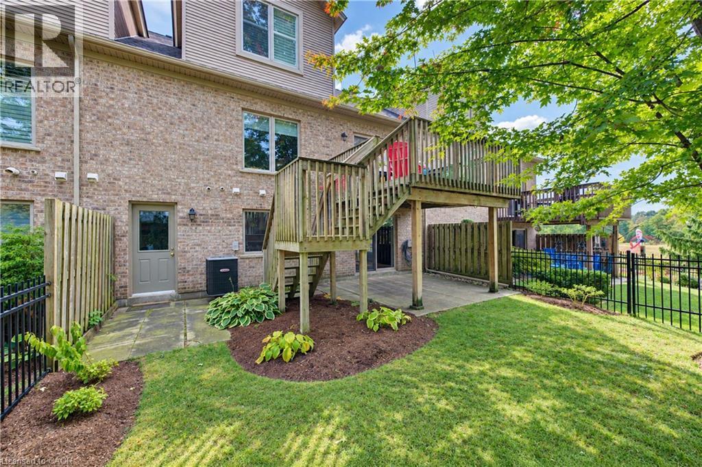 Yard and back door entry to garage hallway. - 222 Chestnut Hill Crescent, Kitchener, ON