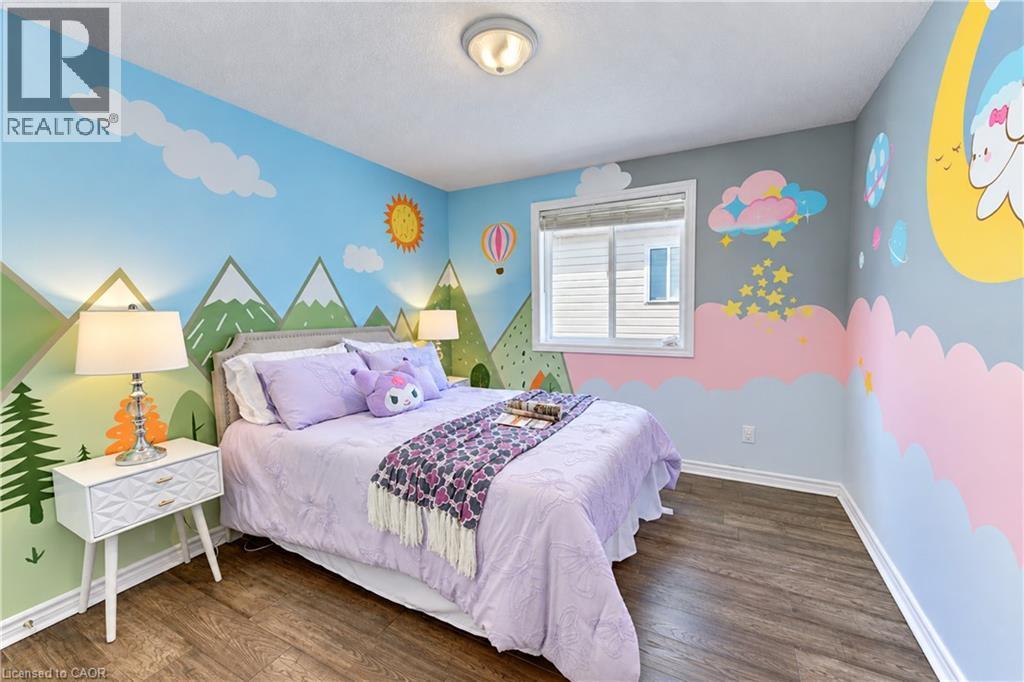 Wood-finish flooring with white baseboards, recessed window, and flush mount lighting - 365 Woolwich Street, Waterloo, ON