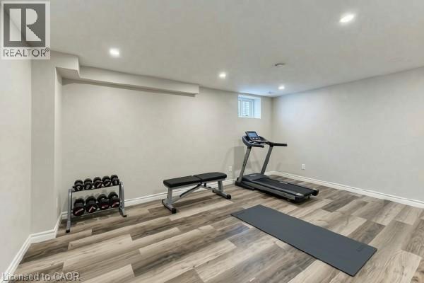 Recessed lighting illuminates the spacious room with wood-finish flooring - 365 Woolwich Street, Waterloo, ON