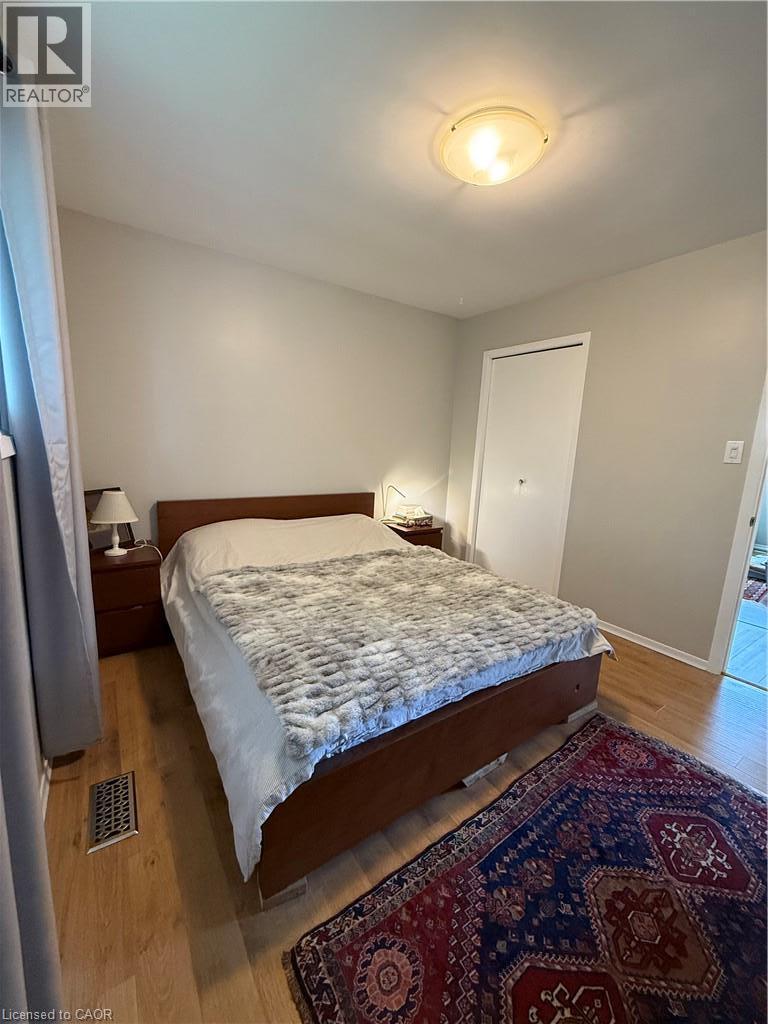 Light wood-finish flooring with a flush-mount ceiling light - 281 Toll Gate Boulevard, Waterloo, ON