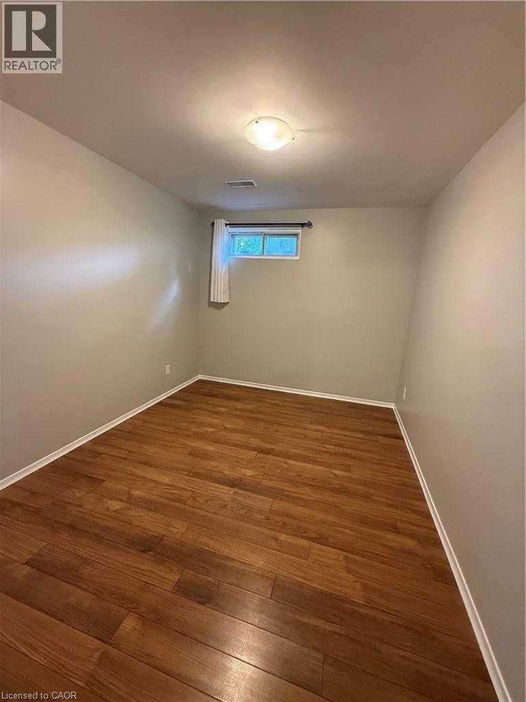 Wood-finish flooring, neutral wall tones, recessed window, and flush mount lighting - 281 Toll Gate Boulevard, Waterloo, ON