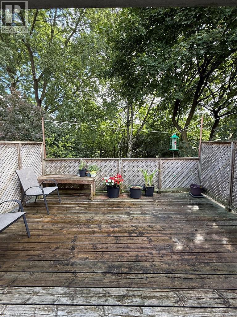Expansive wood deck with lattice privacy fencing and mature surrounding trees - 281 Toll Gate Boulevard, Waterloo, ON