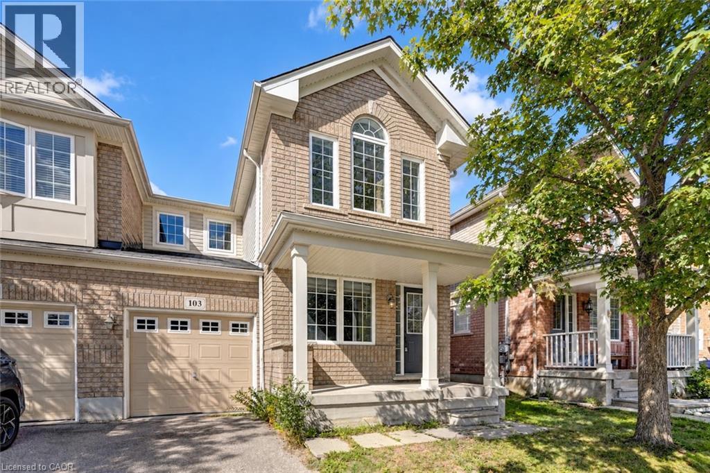Brick facade with covered porch, arched window, and attached garage - 103 Blackbird Circle, Cambridge, ON