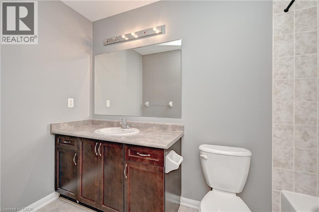 Dark wood-finish vanity with a built-in sink and countertop - 103 Blackbird Circle, Cambridge, ON