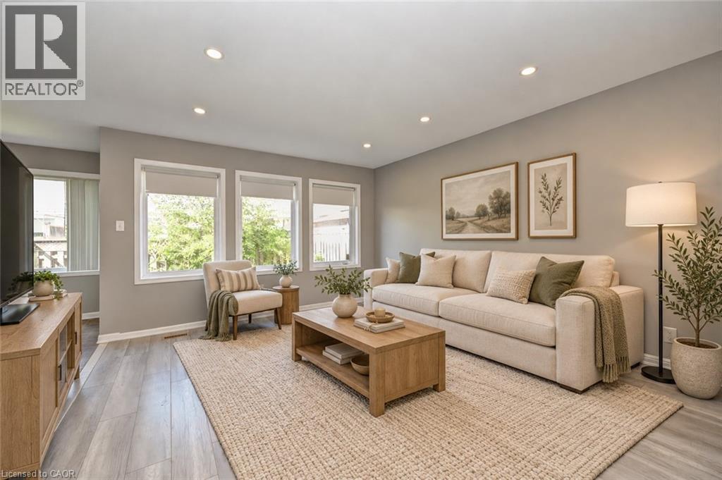 Recessed lighting, wood-finish flooring, and multiple windows with roller shades - 103 Blackbird Circle, Cambridge, ON