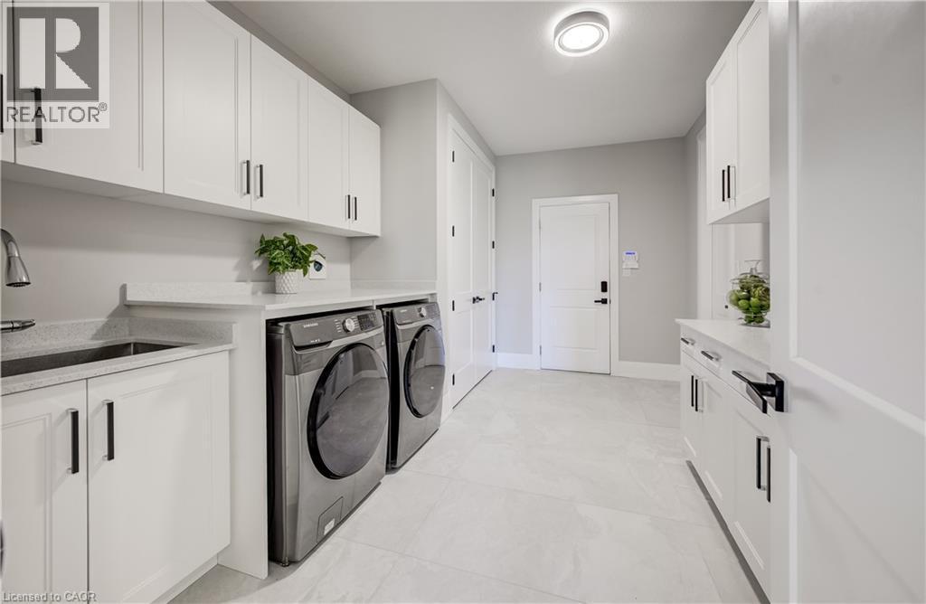 Main floor laundry, double closet, garage entry plus walk-in pantry to the right - 61 Schweitzer Street, Kitchener, ON
