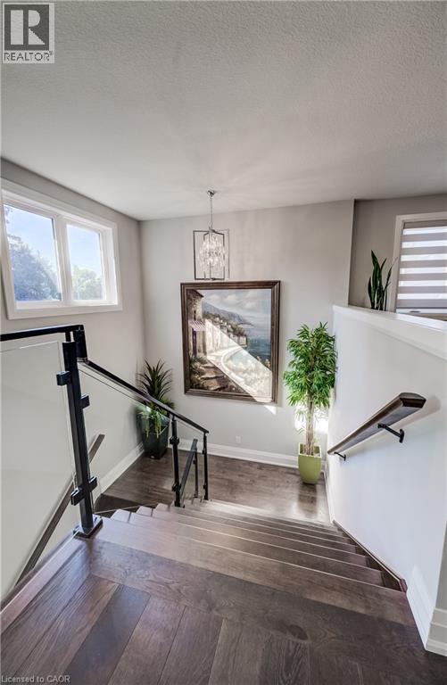 Wide maple staircase with glass & metal railing system - 61 Schweitzer Street, Kitchener, ON