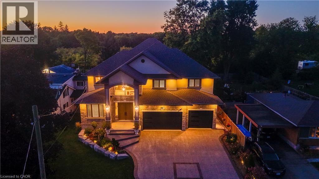 Front of house at dusk.... - 61 Schweitzer Street, Kitchener, ON