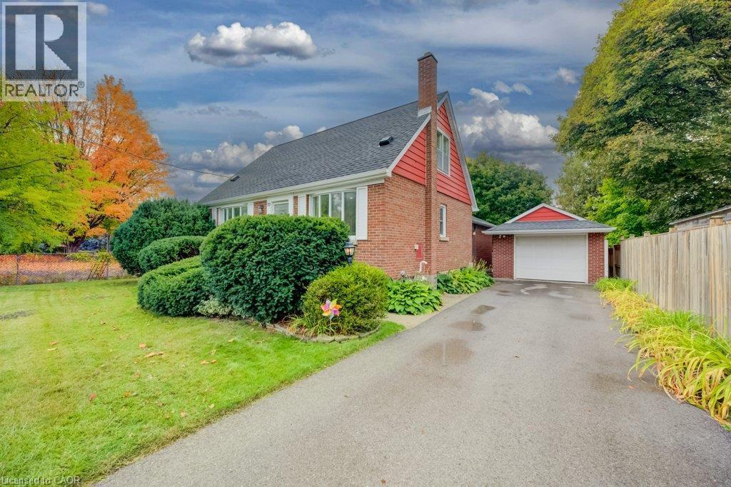 Brick exterior with white trim, a gabled roof, and an attached single-car garage - 37 Margaret Avenue N, Waterloo, ON
