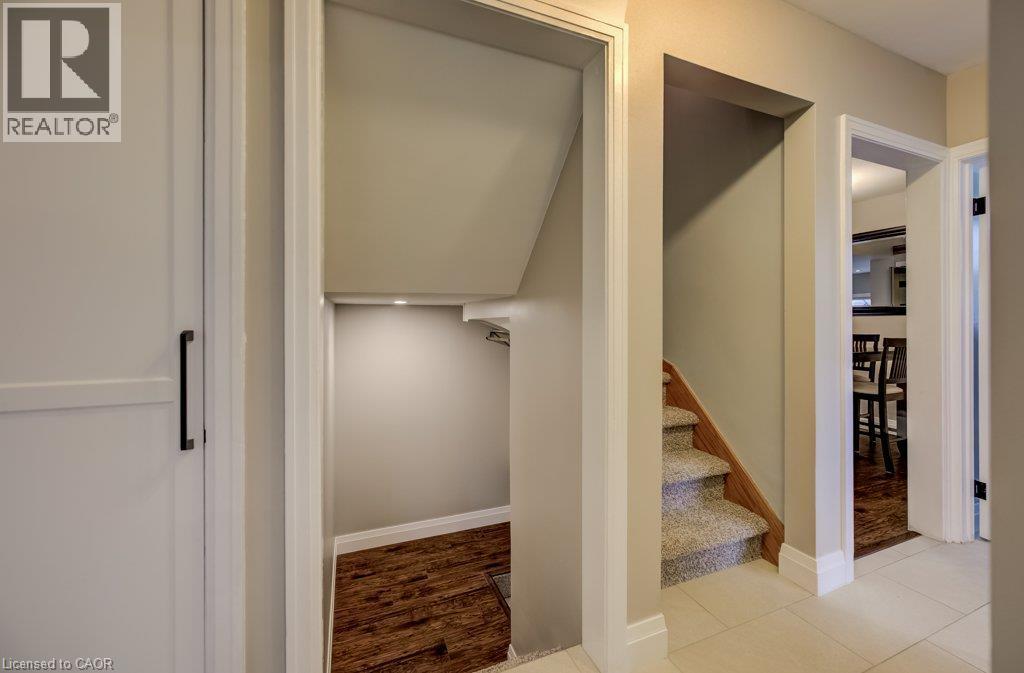 Recessed lighting, wood-finish flooring, under-stair storage, carpeted staircase, and tiled flooring - 37 Margaret Avenue N, Waterloo, ON