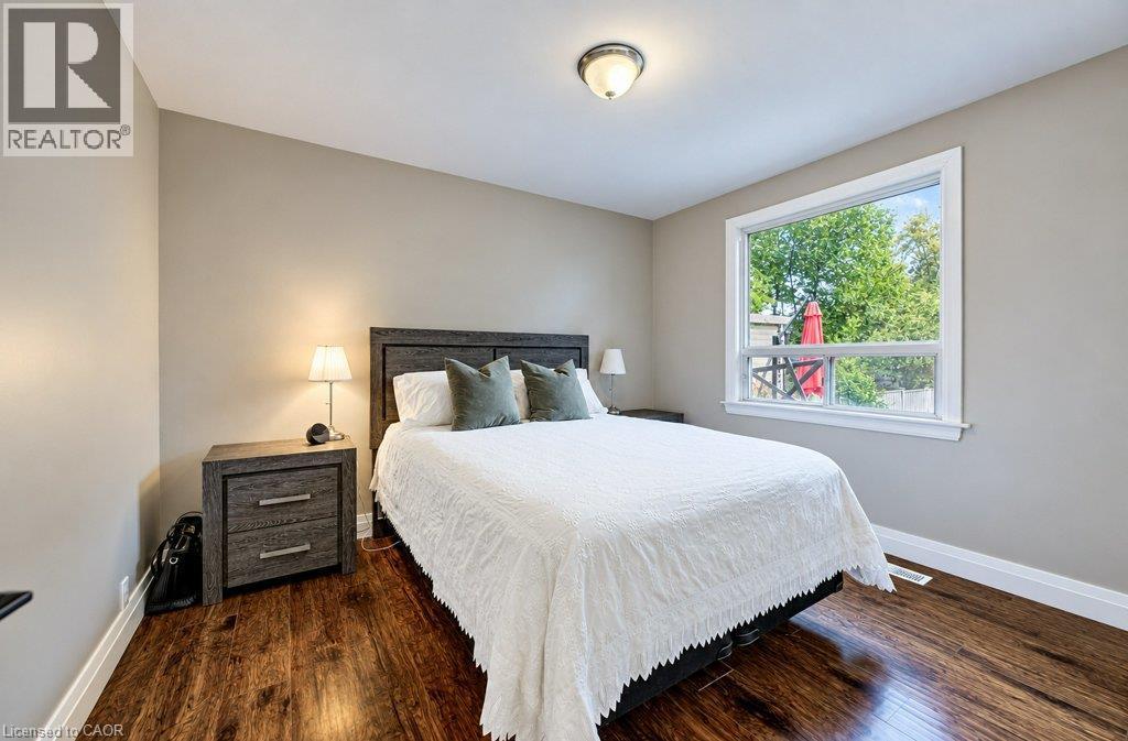 Wood-finish flooring, light neutral wall color, and a large window with white trim - 37 Margaret Avenue N, Waterloo, ON