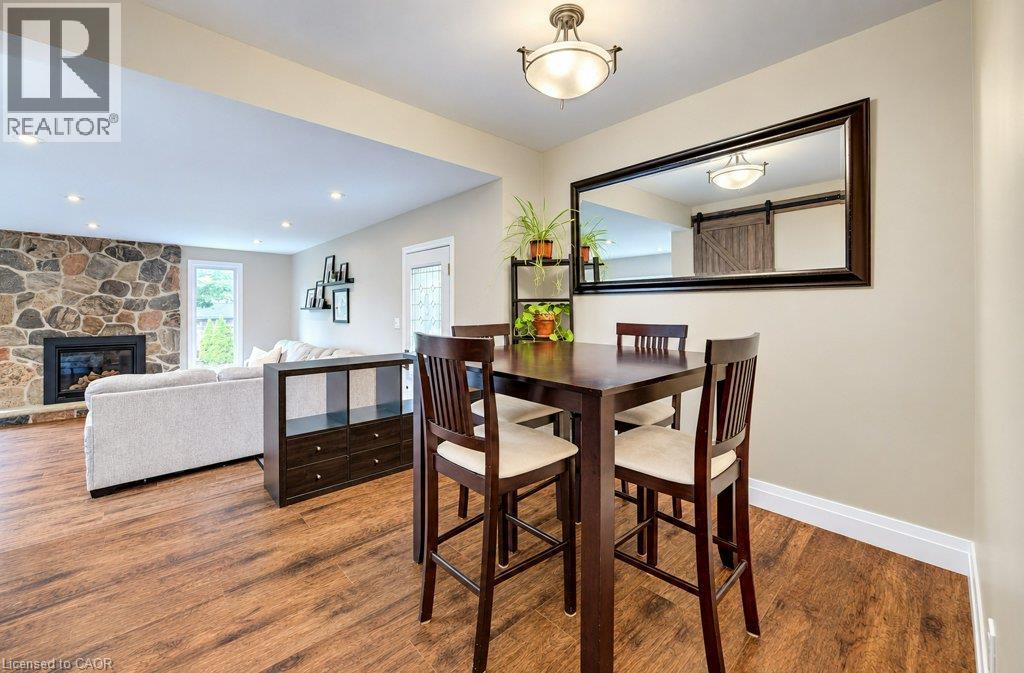 Wood-finish flooring throughout, a stone-clad fireplace, and recessed lighting in the living area - 37 Margaret Avenue N, Waterloo, ON