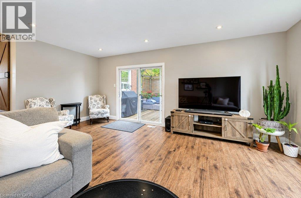 Wood-finish flooring, recessed lighting, and a sliding glass door providing outdoor access - 37 Margaret Avenue N, Waterloo, ON