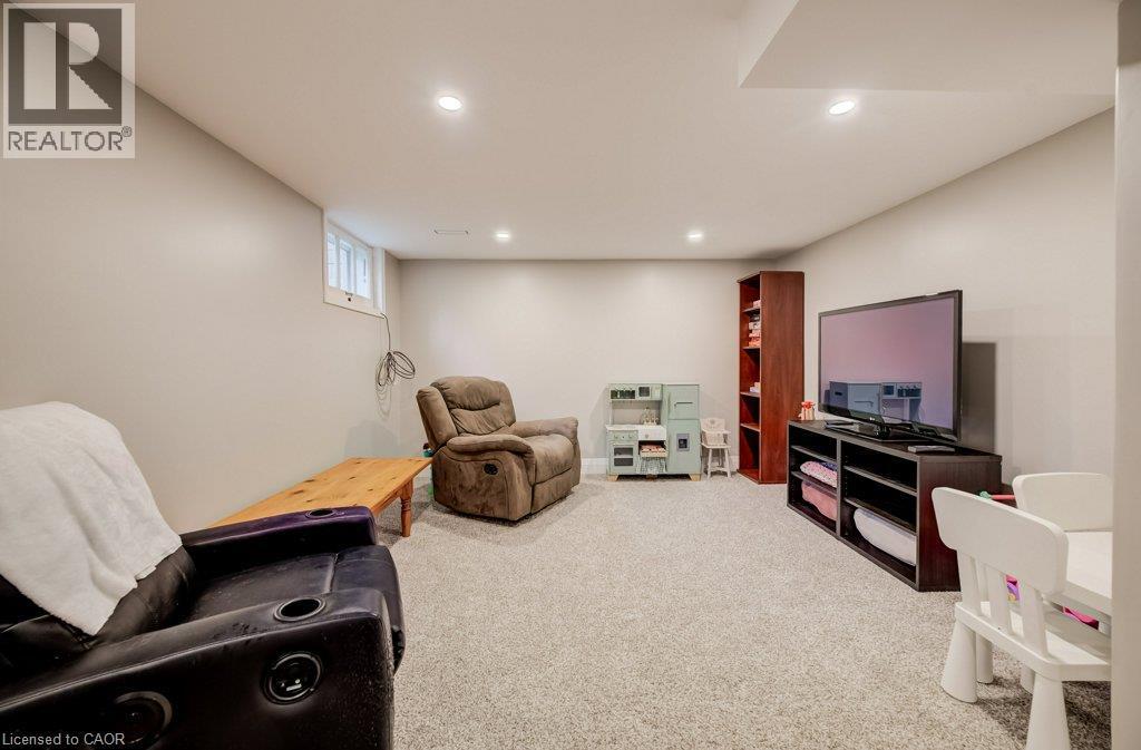 Carpeted room with recessed lighting, an egress window, and light-toned walls - 37 Margaret Avenue N, Waterloo, ON