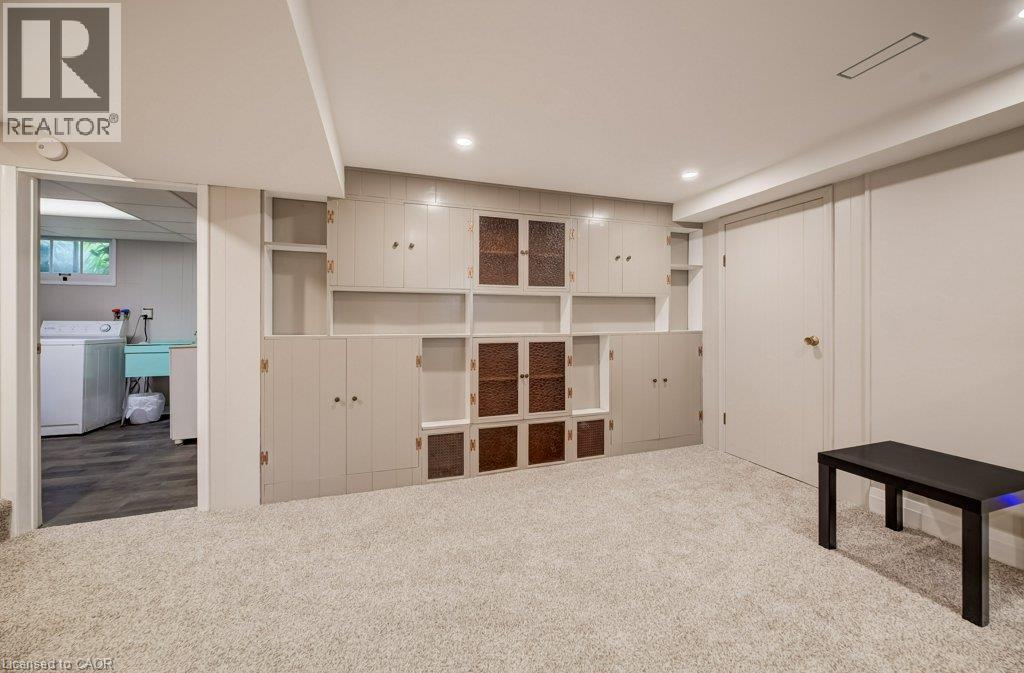 Built-in cabinetry with glass-front accents, recessed lighting, wall-to-wall carpeting, and a durable door - 37 Margaret Avenue N, Waterloo, ON