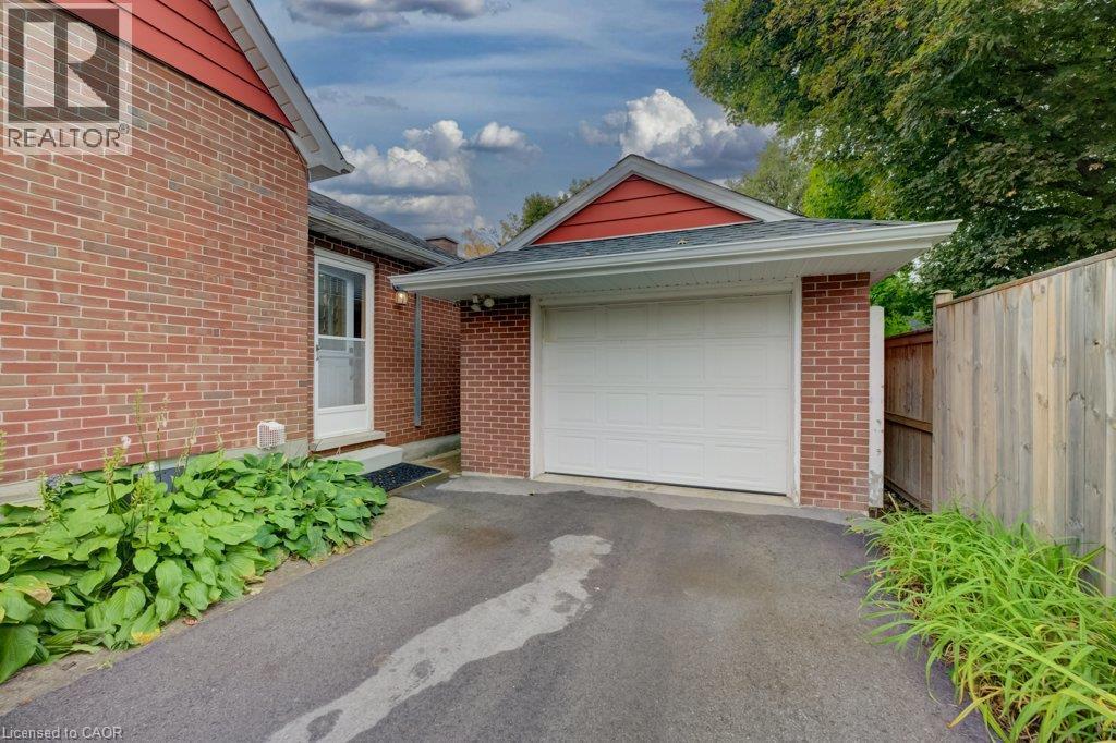 Brick exterior with white garage door and red gable accents - 37 Margaret Avenue N, Waterloo, ON