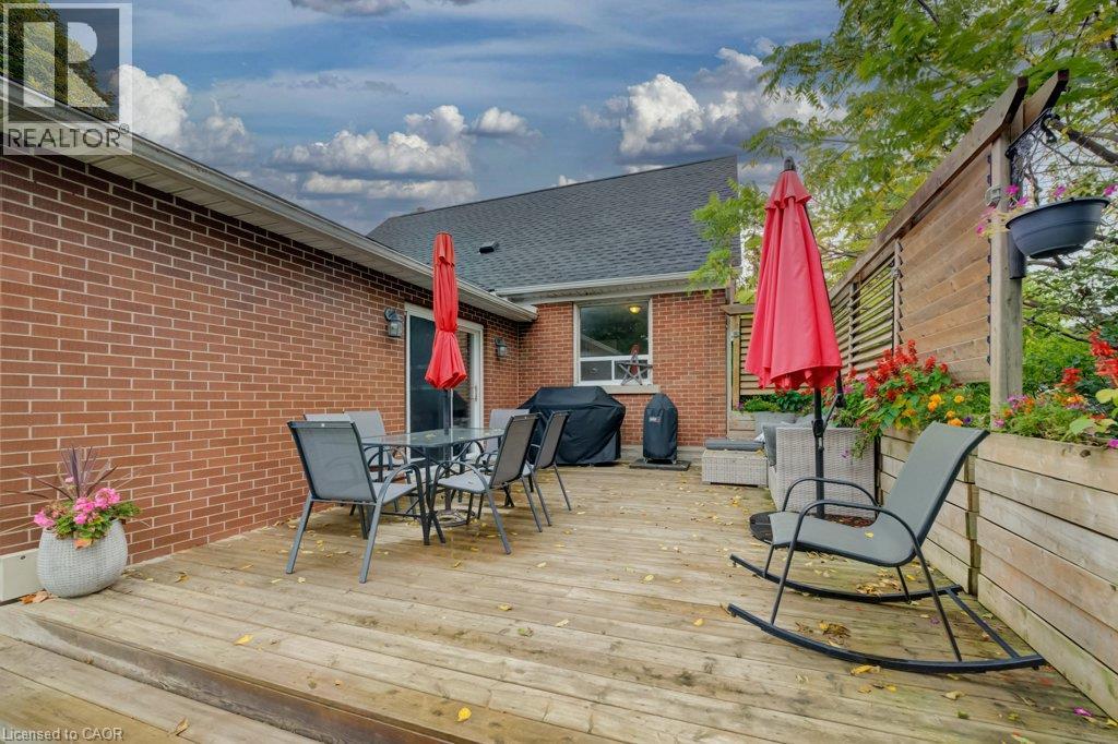 Expansive wood deck with a privacy fence, built-in planter boxes, and brick exterior - 37 Margaret Avenue N, Waterloo, ON