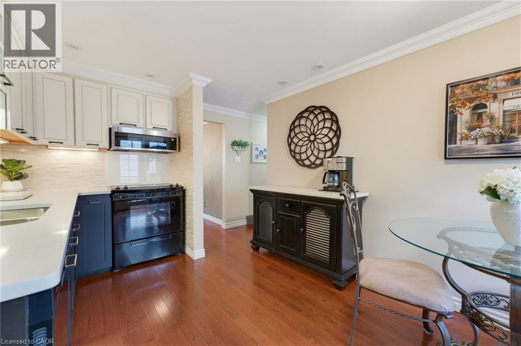 Wood-finish flooring, recessed lighting, and crown molding - 77 Yellow Birch Drive, Kitchener, ON