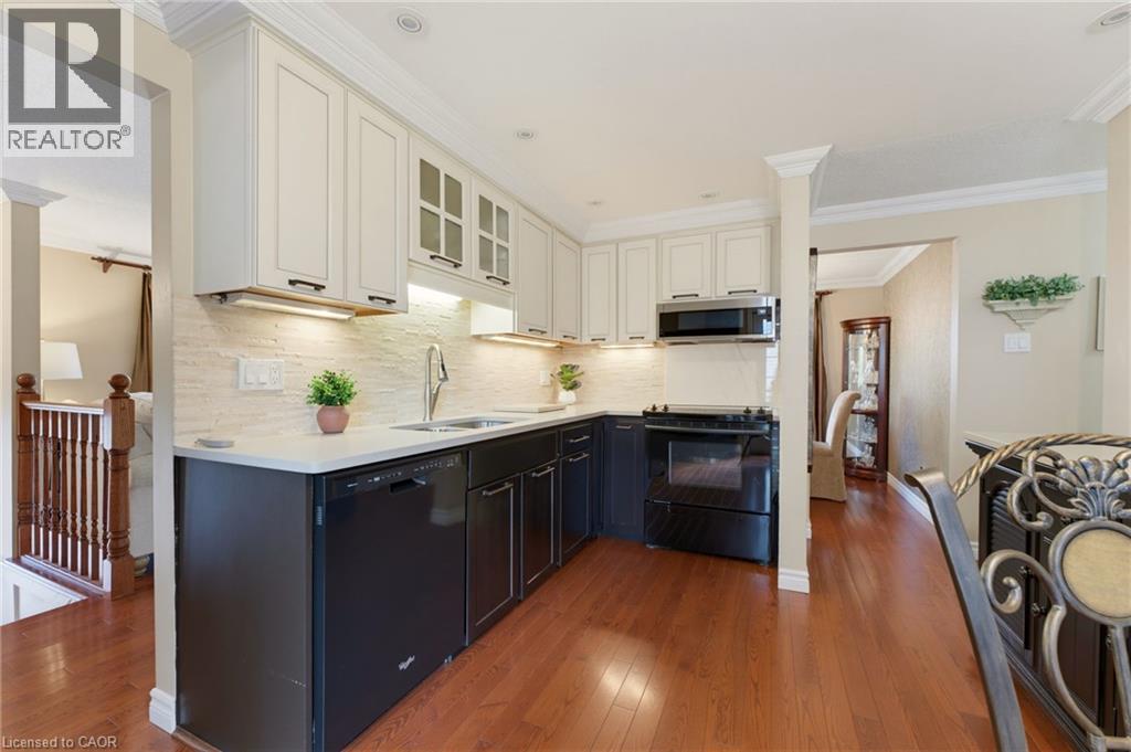 Kitchen with two-tone kitchen cabinetry, under-cabinet lighting. - 77 Yellow Birch Drive, Kitchener, ON