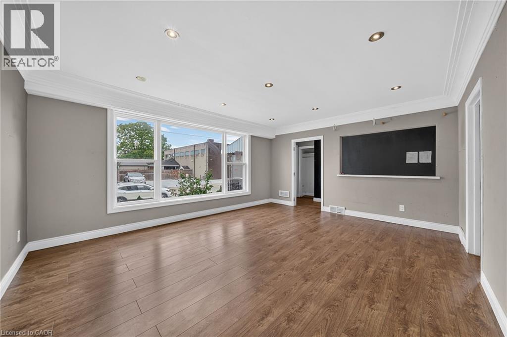 Recessed lighting, crown molding, wood-finish flooring, and a wide window with white trim - 11 Selkirk Avenue, Hamilton, ON