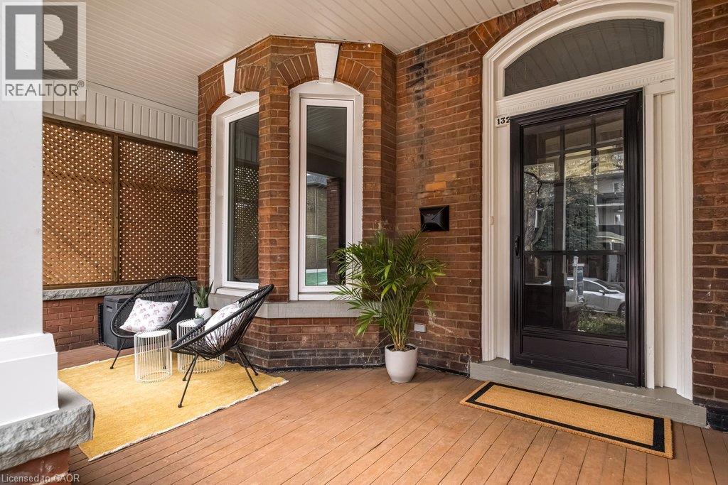 Circa 1882: This beautifully maintained home retains its original front door, complete with a classic door knocker and transom, adding to its timeless historic charm. - 132 Herkimer Street, Hamilton, ON