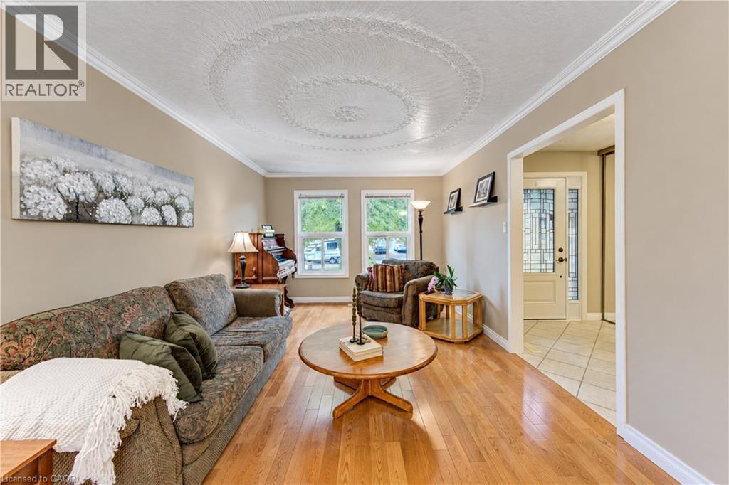 Hardwood-finish flooring, crown molding, double pane windows, and a decorative ceiling medallion - 104 Deerwood Crescent, Kitchener, ON