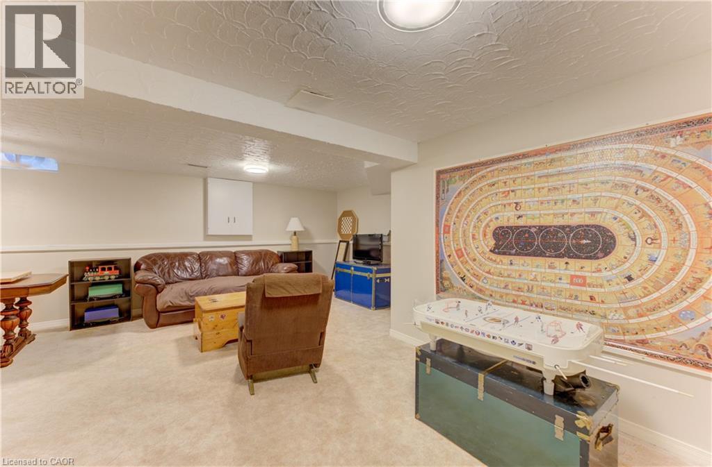 Carpeted flooring, recessed lighting, and wall-mounted cabinetry - 104 Deerwood Crescent, Kitchener, ON