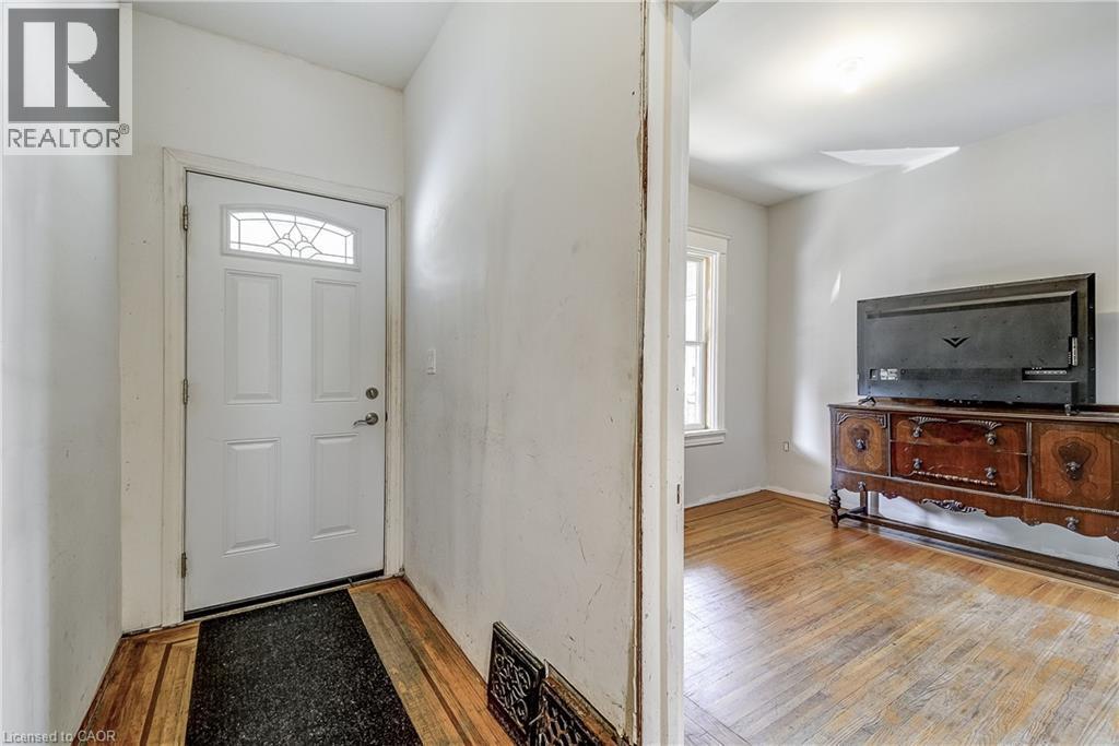 Entry door with decorative glass inserts and wood-finish flooring - 11 Elm Street, Hamilton, ON