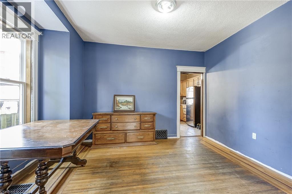 Hardwood flooring throughout, bright walls, and a recessed ceiling light fixture - 11 Elm Street, Hamilton, ON