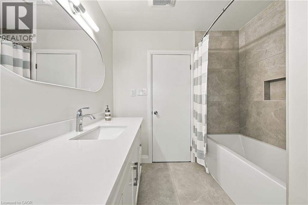 Integrated vanity with an undermount sink and polished chrome faucet - 662 Dynes Road, Burlington, ON
