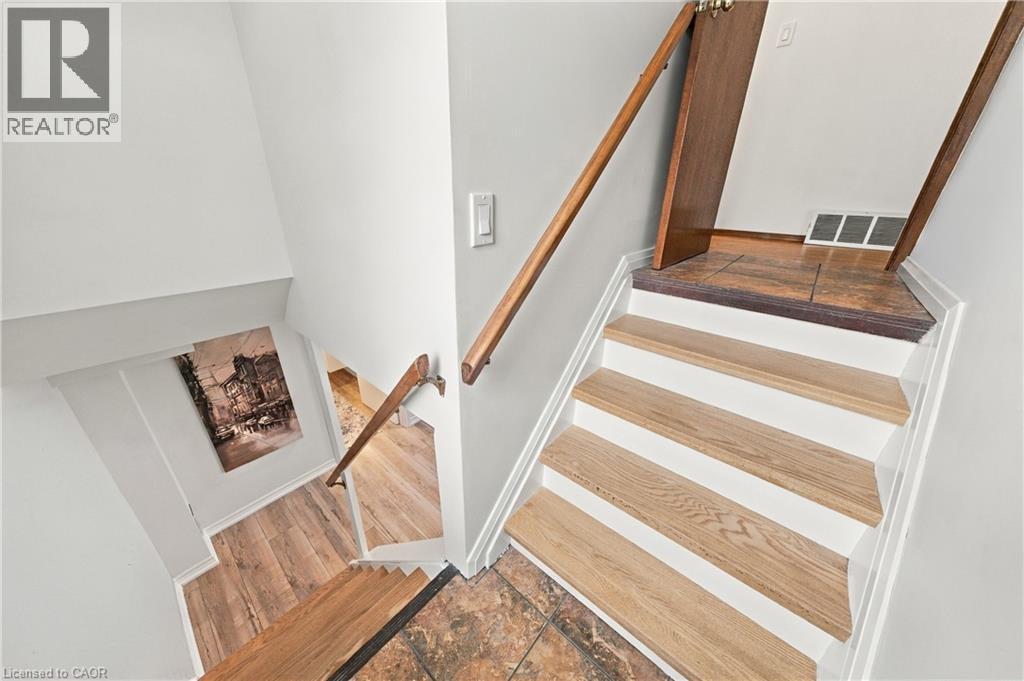 Staircase with wood-finish treads and risers, complemented by wood-finish handrails - 662 Dynes Road, Burlington, ON