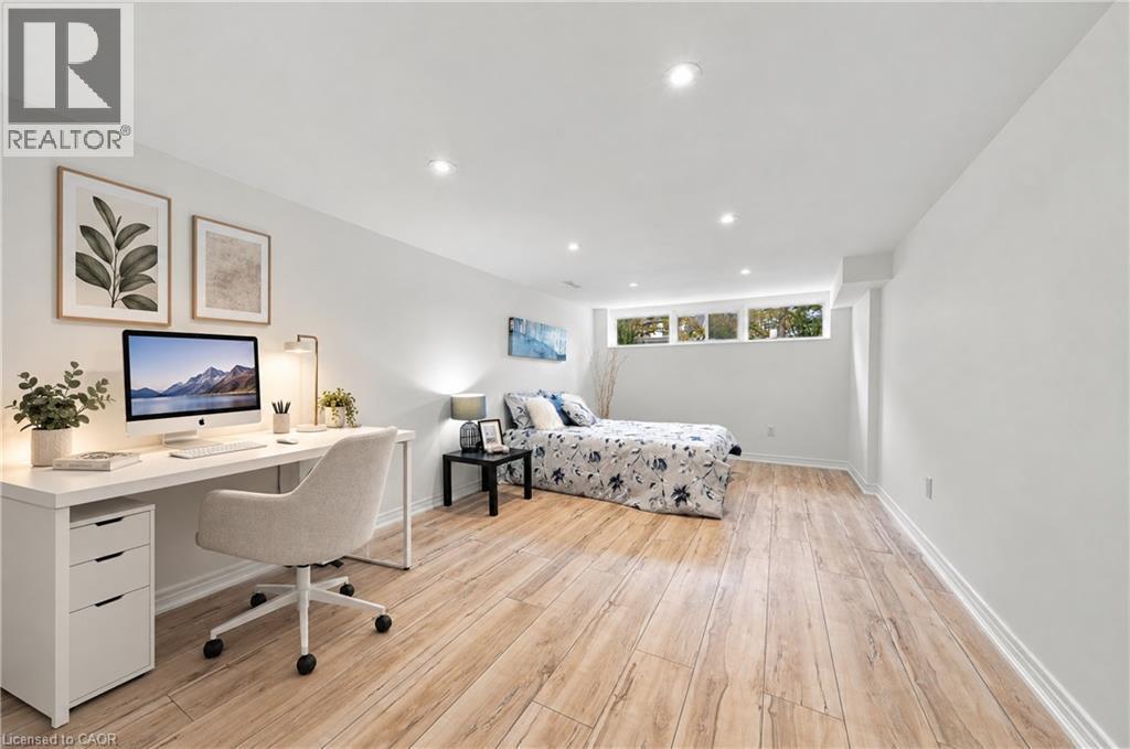 Recessed lighting, light wood-finish flooring, white walls, and multiple transom windows - 662 Dynes Road, Burlington, ON