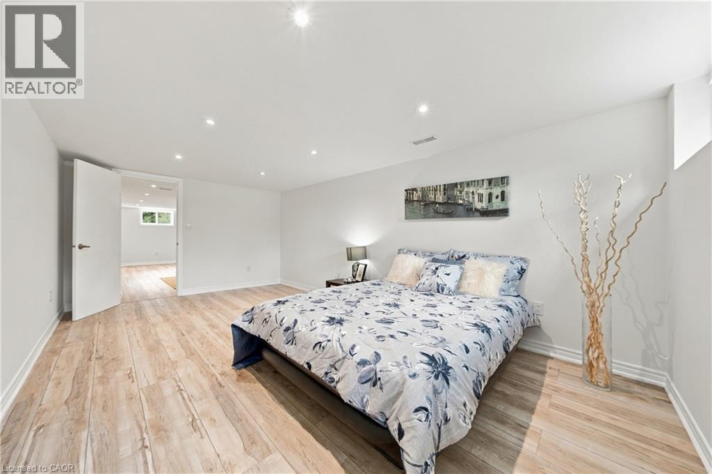 Recessed lighting illuminates wood-finish flooring - 662 Dynes Road, Burlington, ON