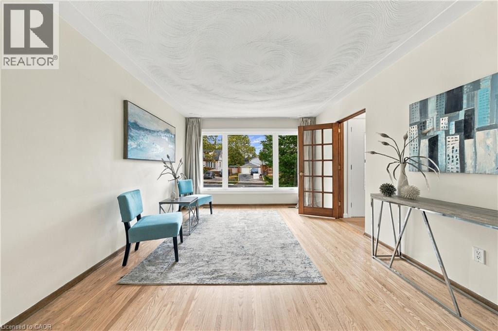 Light wood-finish flooring with neutral wall tones - 662 Dynes Road, Burlington, ON