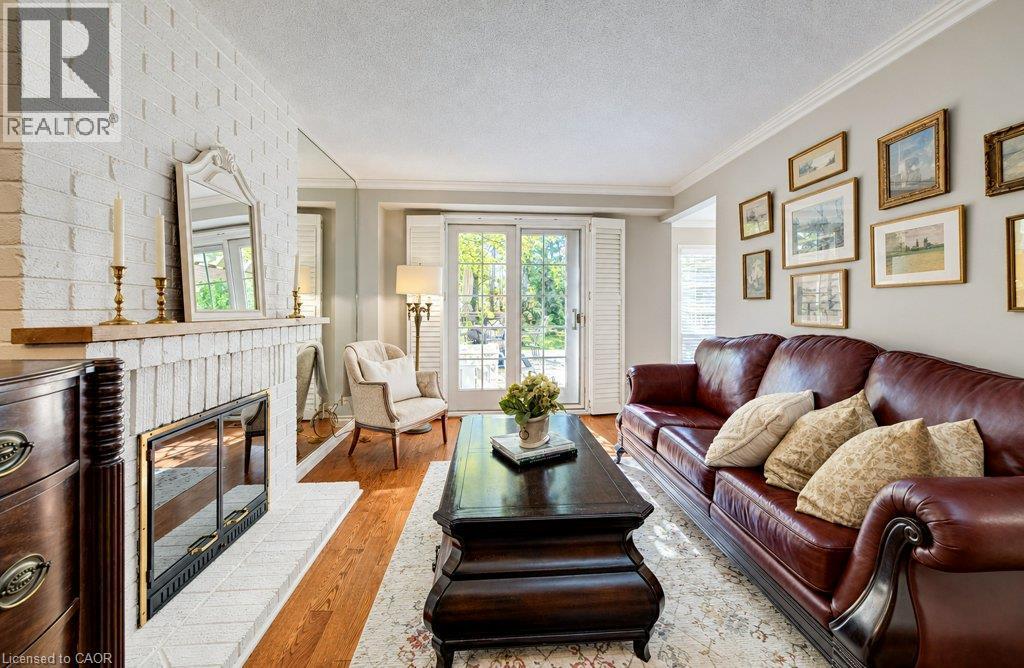 Main floor family room with fireplace and sliders to deck - 469 Westvale Drive, Waterloo, ON