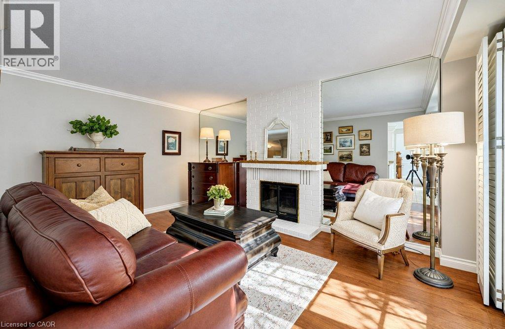 Main floor family room with fireplace and sliders to deck - 469 Westvale Drive, Waterloo, ON