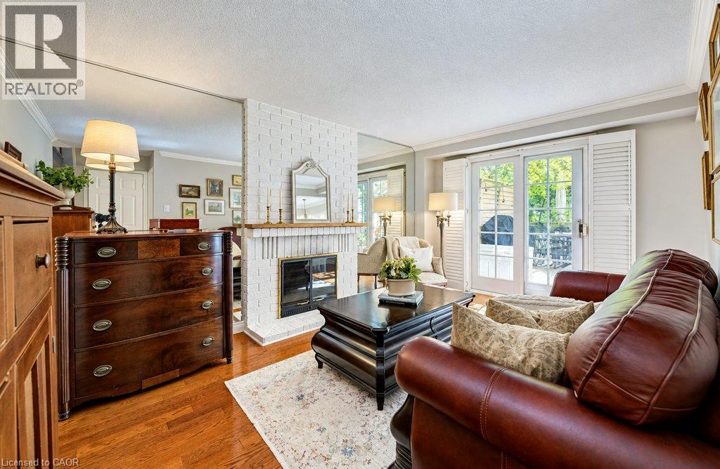 Main floor family room with fireplace and sliders to deck - 469 Westvale Drive, Waterloo, ON