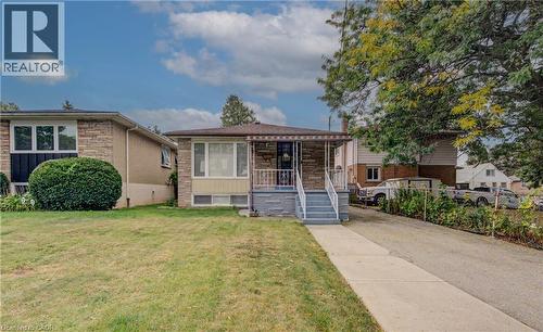 Stone facade home with a covered front entrance and front porch - 465 Herkimer Street, Hamilton, ON 