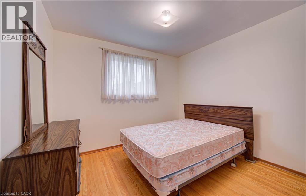 Hardwood flooring, window with sheer curtains, ceiling-mounted light fixture - 465 Herkimer Street, Hamilton, ON