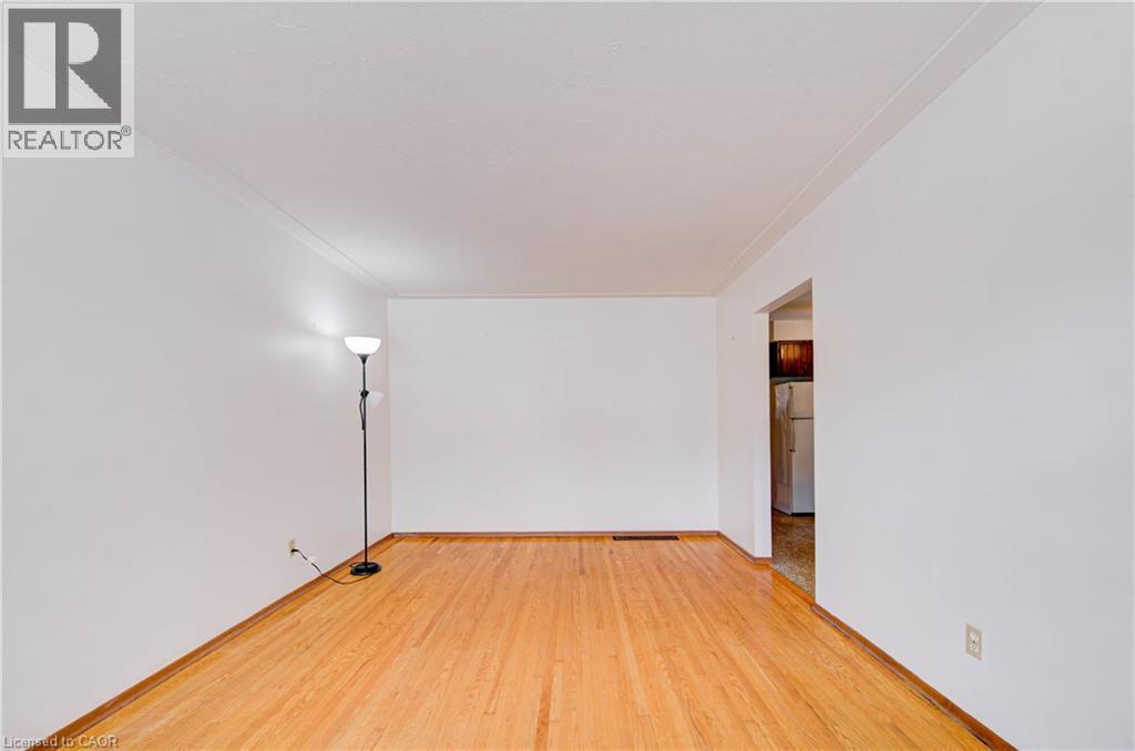 Hardwood flooring throughout, with white walls and crown molding - 465 Herkimer Street, Hamilton, ON