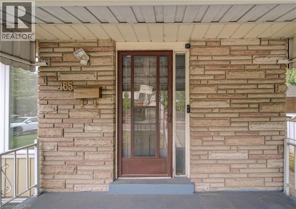 Stone veneer exterior with a covered porch and metal railing - 465 Herkimer Street, Hamilton, ON