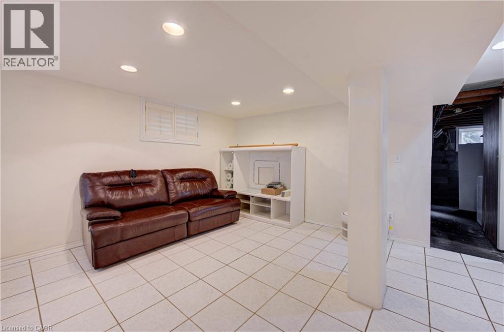 Recessed lighting, tile flooring, window with louvered shutters, and built-in shelving unit - 465 Herkimer Street, Hamilton, ON