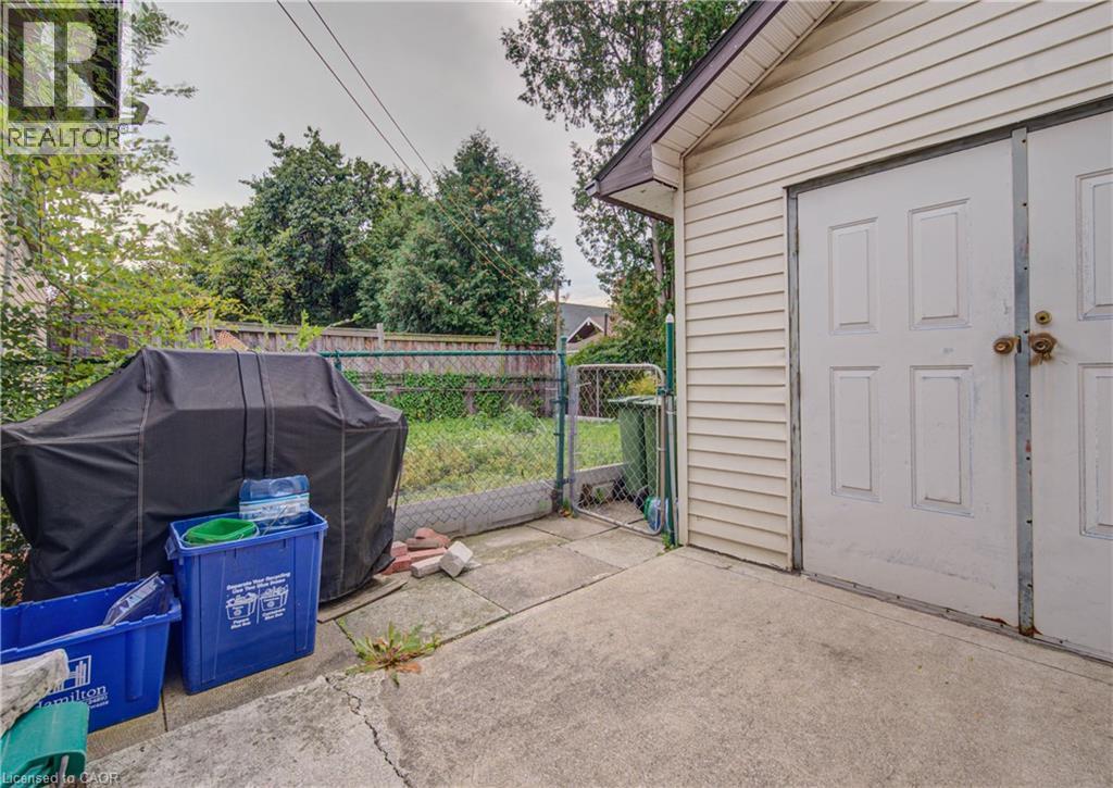 Detached structure with panel siding, double entry doors, and an overhang - 465 Herkimer Street, Hamilton, ON