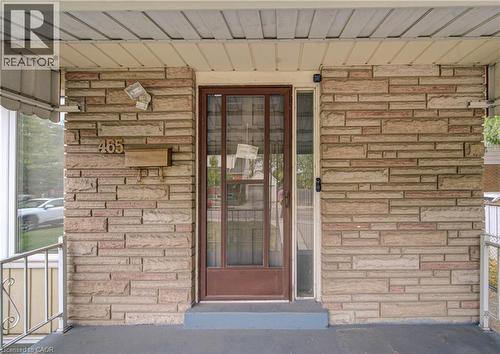 Stone veneer exterior with a covered porch and metal railing - 465 Herkimer Street, Hamilton, ON 