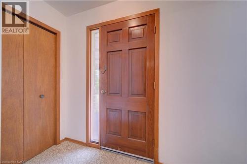 Wood-paneled entry door with sidelight and gold-toned hardware - 465 Herkimer Street, Hamilton, ON 