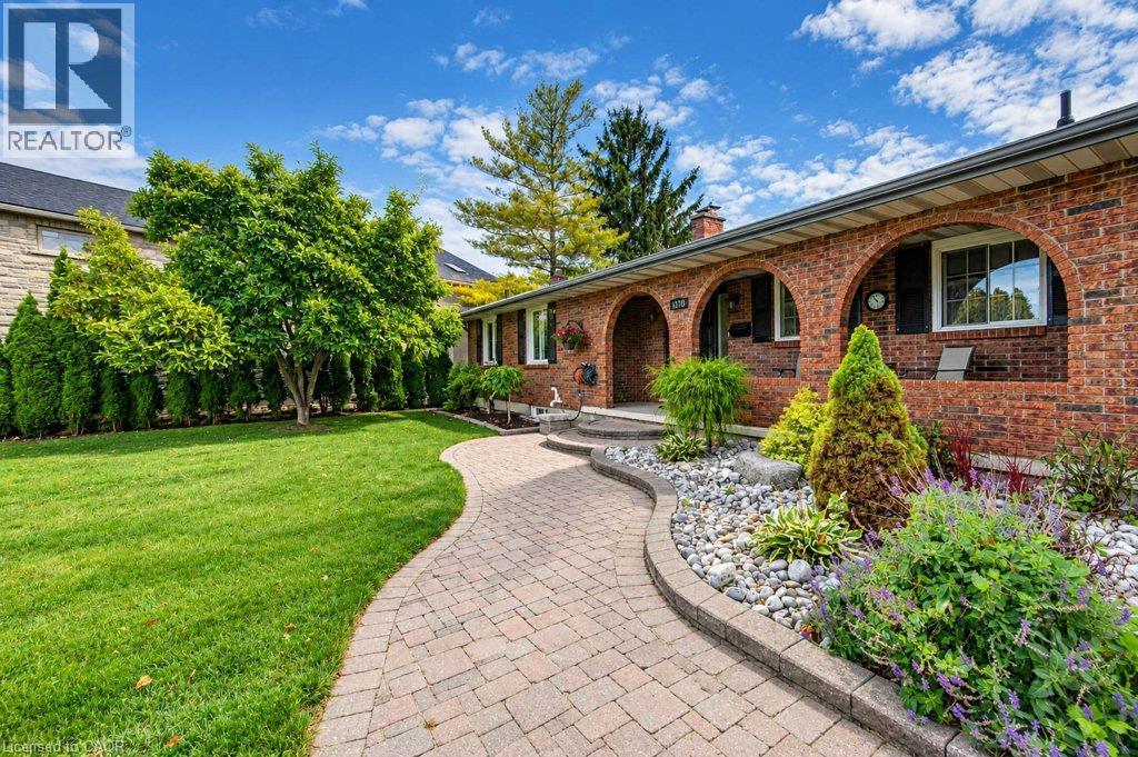 Brick exterior with arched entryways and contrasting black shutters - 1370 Thorman Place, Cambridge, ON