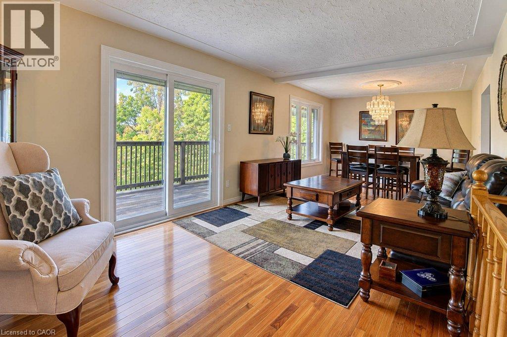 Hardwood flooring, sliding glass door, recessed ceiling detail, and a built-in balcony - 1370 Thorman Place, Cambridge, ON