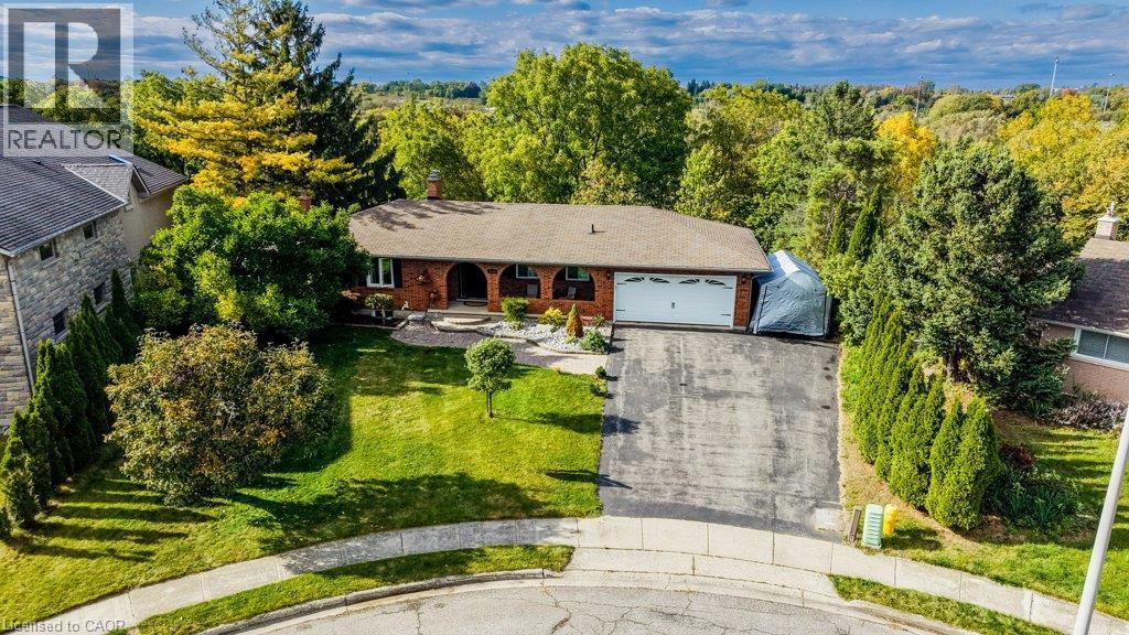 Brick exterior with an attached garage, paved driveway, and manicured front lawn - 1370 Thorman Place, Cambridge, ON