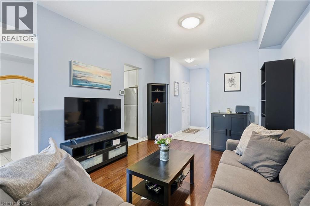 Hardwood-finish flooring and a white entry door - 1076 Ryckman Common, Burlington, ON