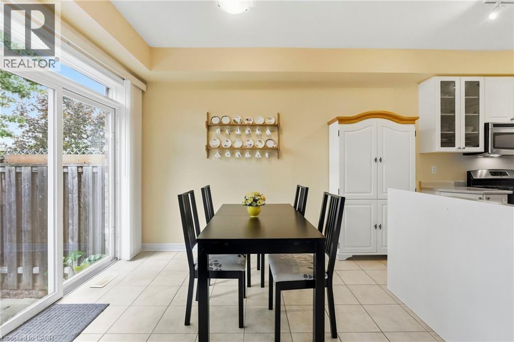 Sliding glass door, tiled flooring & microwave - 1076 Ryckman Common, Burlington, ON